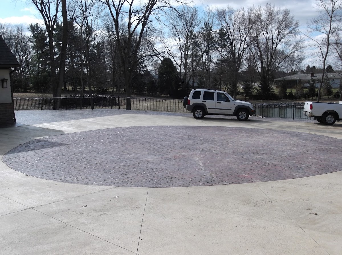 Finished stained and stamped circular concrete driveway